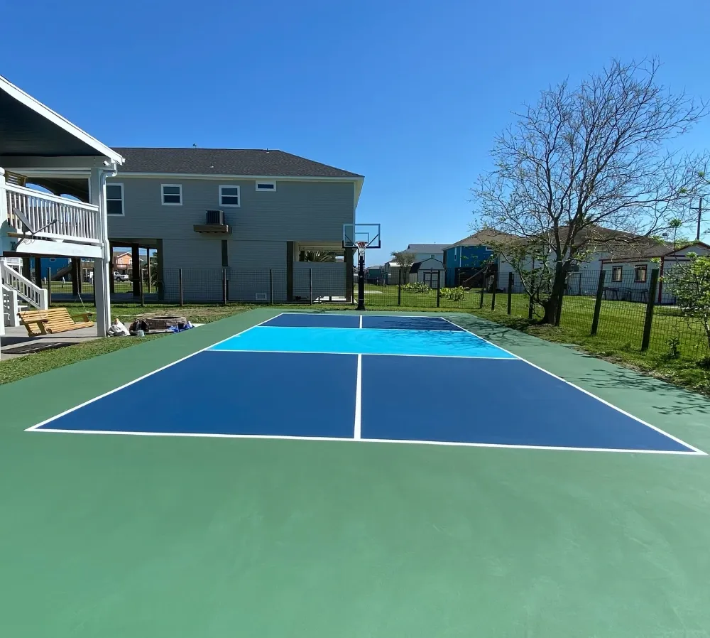 Backyard pickleball court beside a Texas home