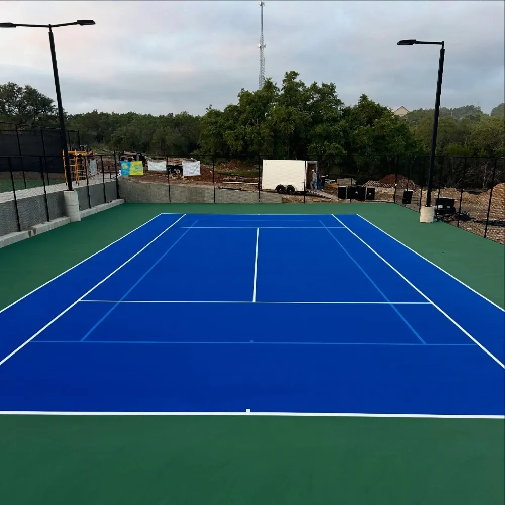 Blue and green tennis court with lighting